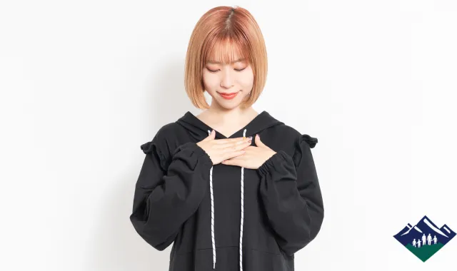 胸に手を当てる女性